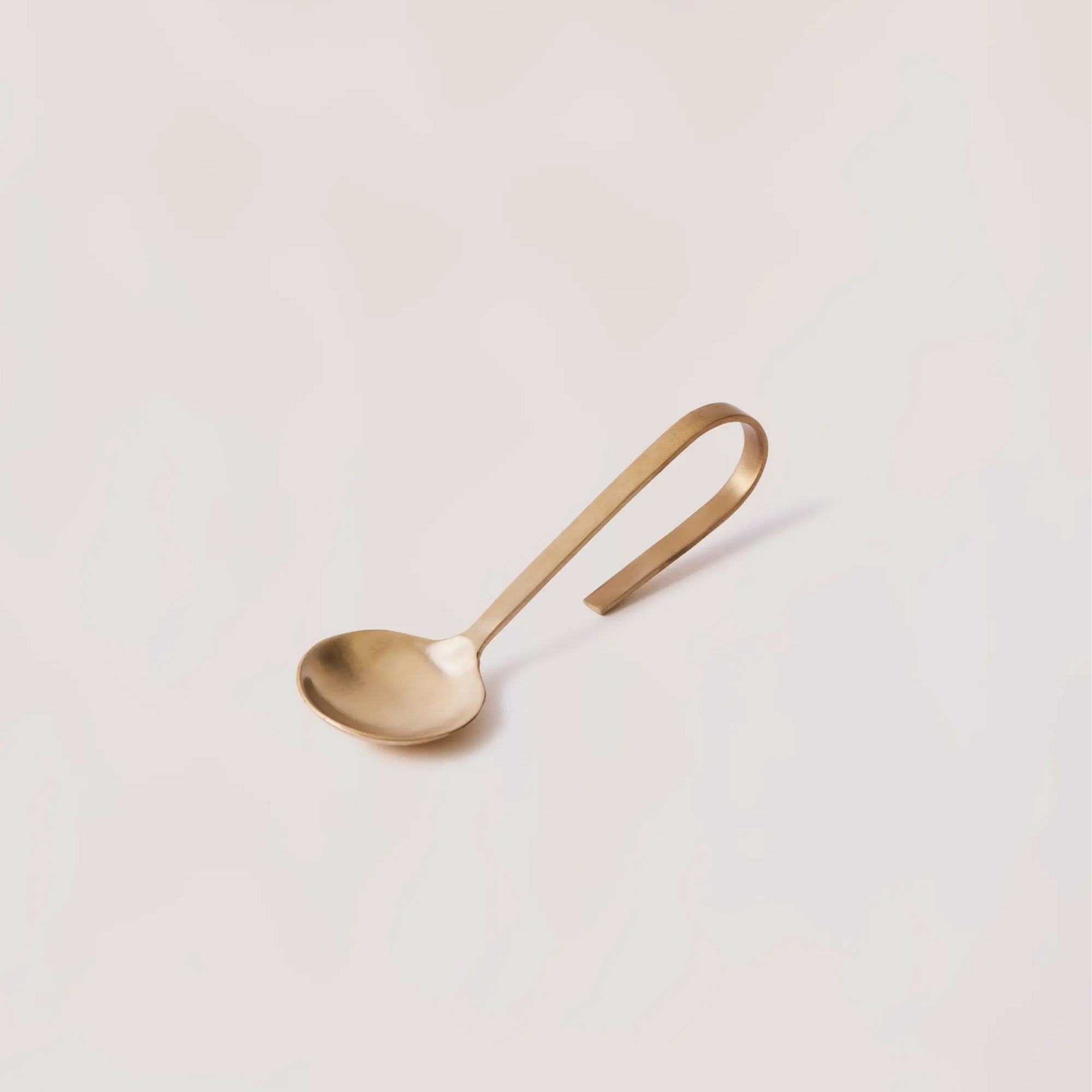 looped brass spoon