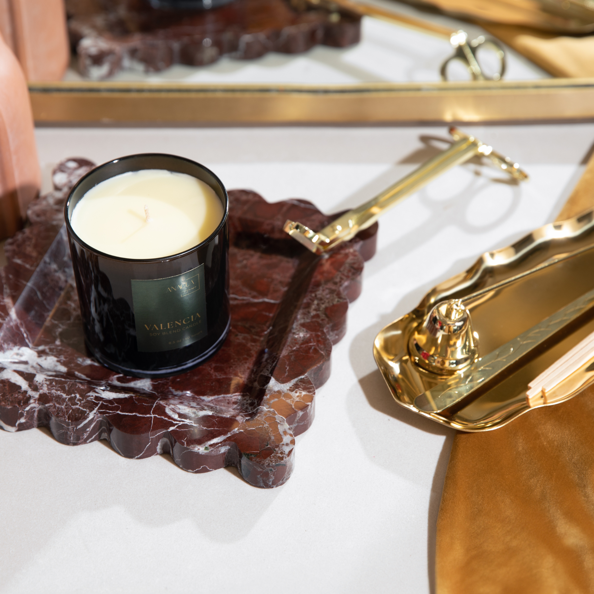 red marble candle tray with gold accessories