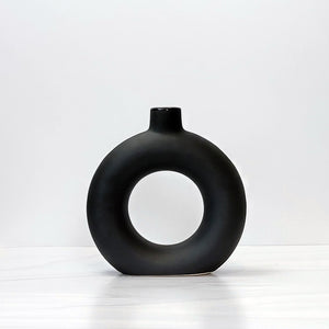 Small black doughnut-shaped Otto vase.